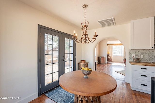 dining space featuring dark hardwood / wood-style floors and french doors