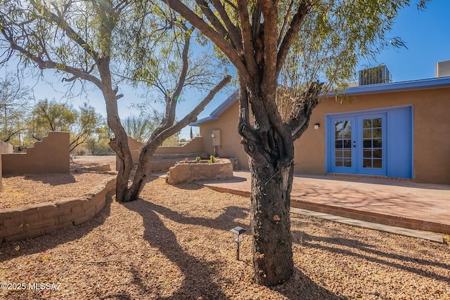 view of yard with a patio area and french doors