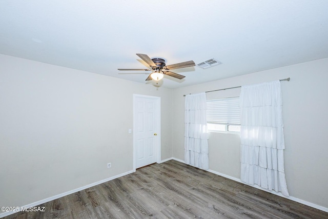 unfurnished room featuring ceiling fan and hardwood / wood-style flooring