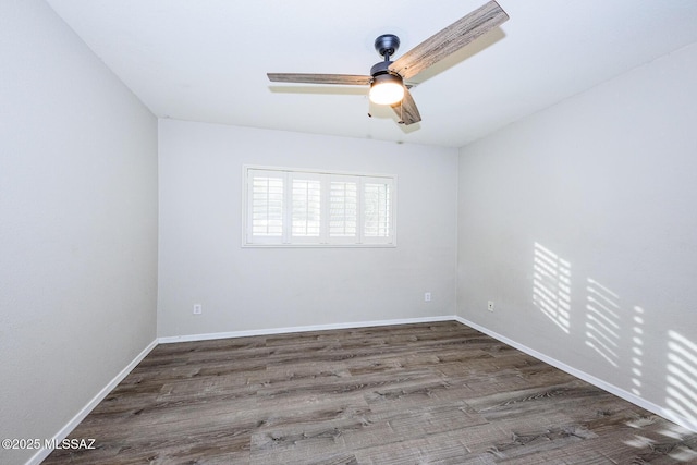 spare room with ceiling fan and dark wood-type flooring