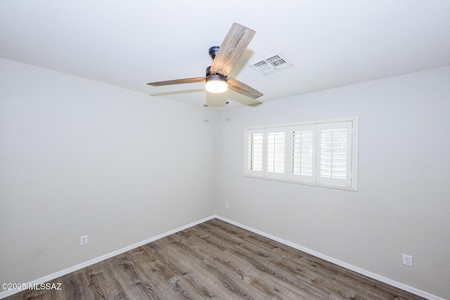 empty room featuring ceiling fan and hardwood / wood-style flooring