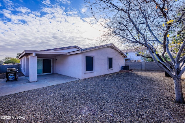 back of property with a patio and cooling unit