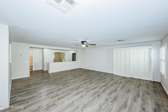 unfurnished living room featuring ceiling fan and light wood-type flooring