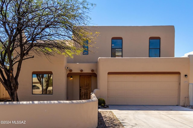 southwest-style home featuring a garage