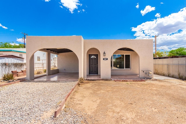 pueblo-style house with a carport