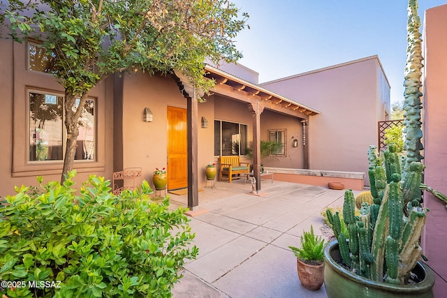 rear view of property featuring a patio area