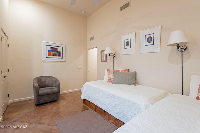 bedroom featuring ceiling fan, a towering ceiling, and concrete flooring