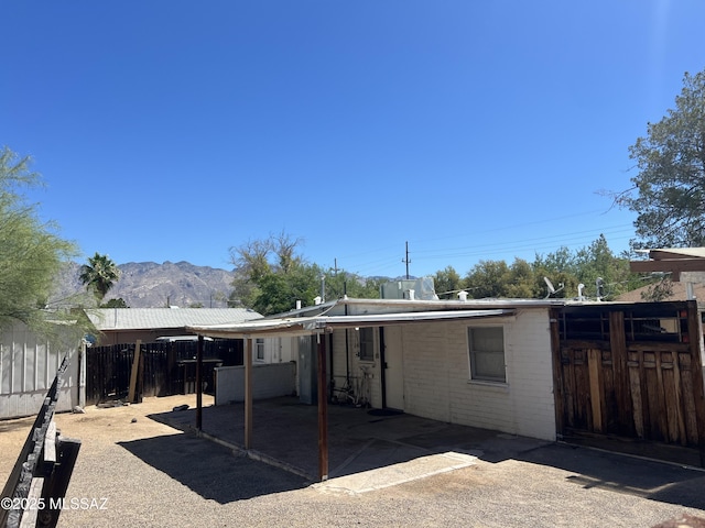 back of property with a mountain view