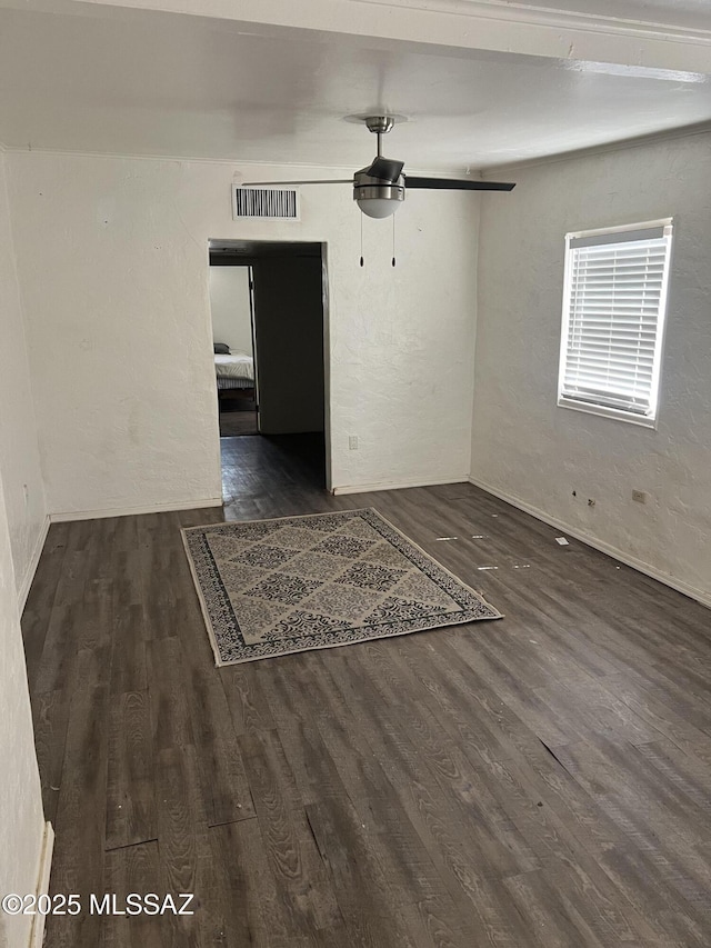 unfurnished room with dark hardwood / wood-style flooring and ceiling fan