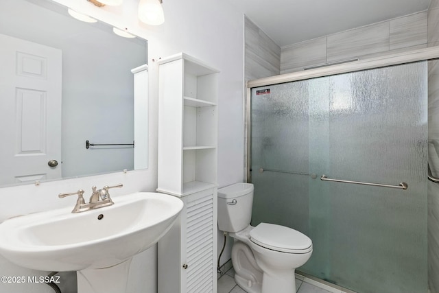 bathroom with walk in shower, toilet, and sink