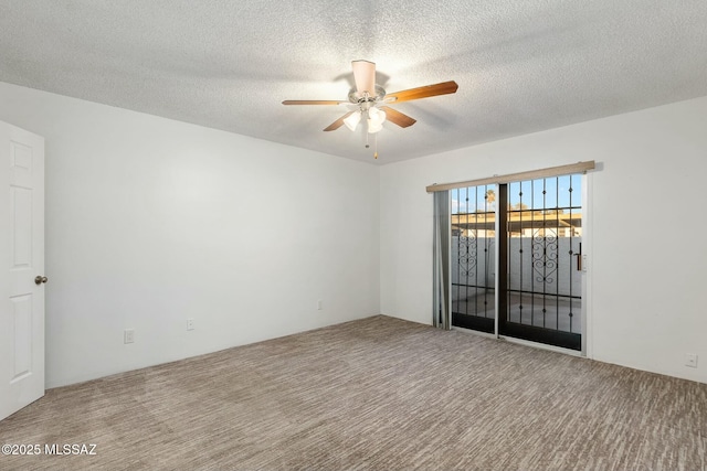 empty room featuring a textured ceiling, ceiling fan, and carpet flooring