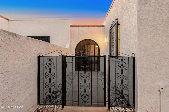 view of gate at dusk