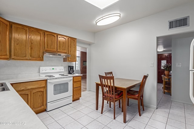 kitchen featuring light tile patterned floors and electric range