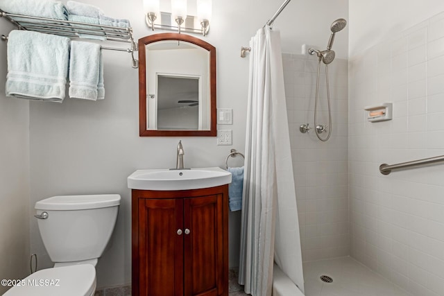 bathroom featuring a shower with curtain, toilet, and vanity