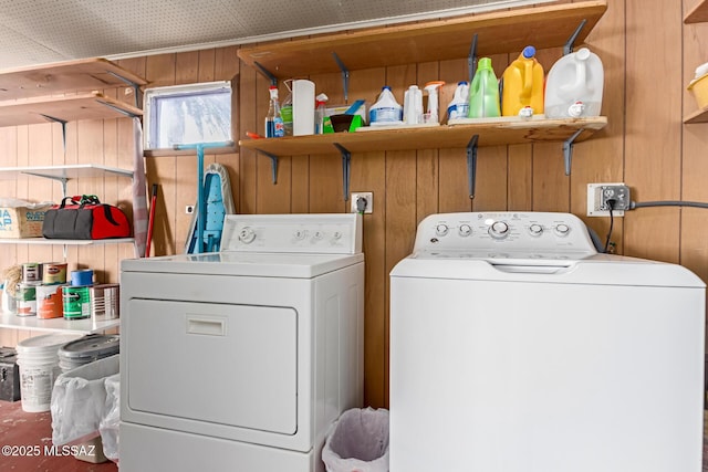 washroom featuring independent washer and dryer and wood walls