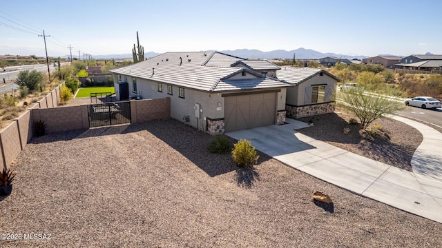 view of front of property with a mountain view and a garage