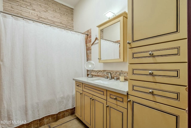 bathroom with decorative backsplash and vanity