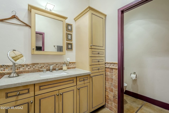 bathroom featuring tile patterned floors, vanity, toilet, and decorative backsplash