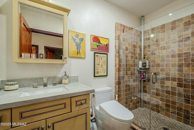 bathroom featuring vanity, toilet, and an enclosed shower