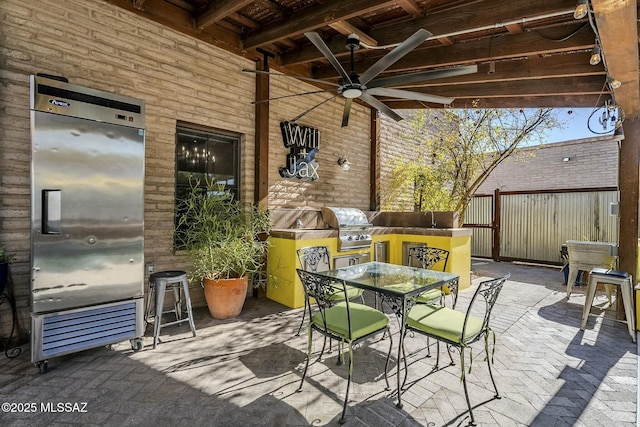 view of patio / terrace featuring ceiling fan, sink, and grilling area