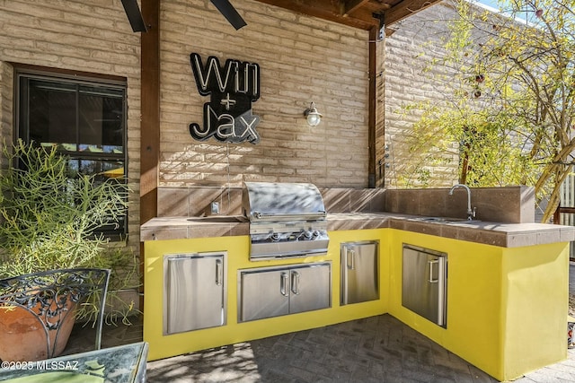 view of patio / terrace with a grill, exterior kitchen, and sink