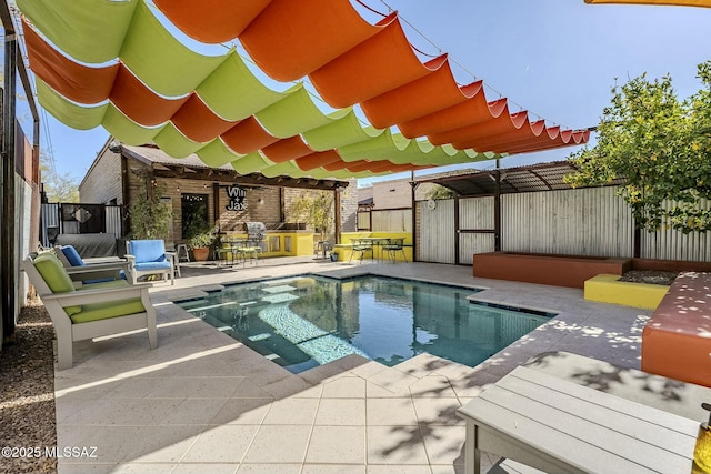 view of pool with a patio and exterior kitchen