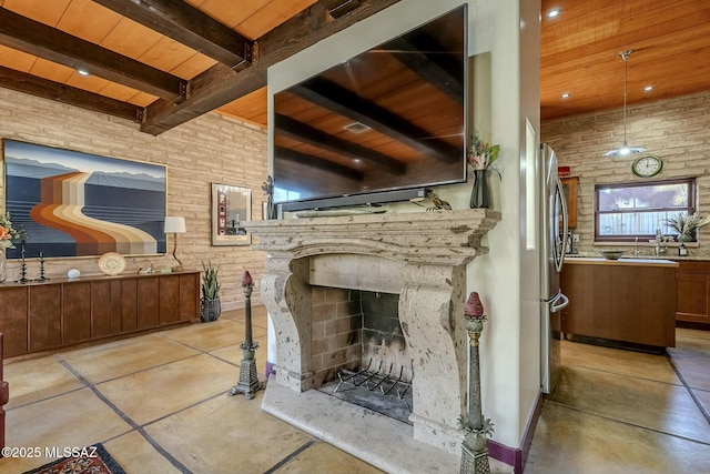 interior space with beam ceiling, wooden ceiling, and sink