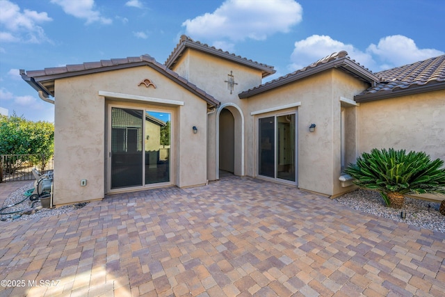 rear view of property featuring a patio