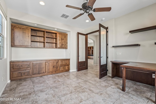 unfurnished office with ceiling fan and french doors