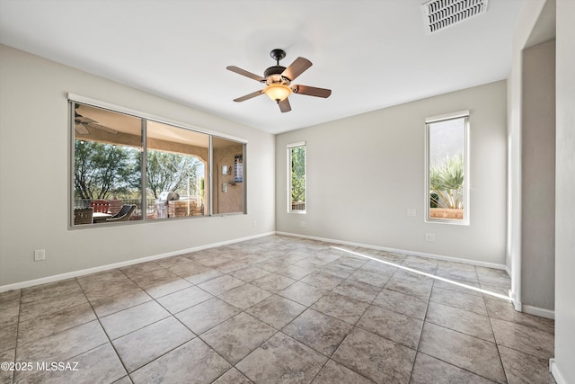 tiled empty room with ceiling fan