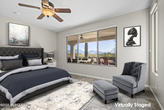 tiled bedroom featuring ceiling fan, a closet, and a mountain view