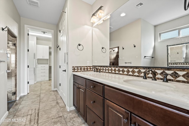 bathroom with vanity and tasteful backsplash