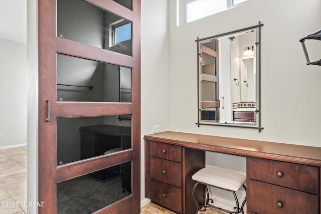 home office with light tile patterned floors