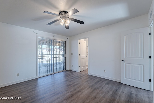 spare room featuring dark hardwood / wood-style flooring and ceiling fan