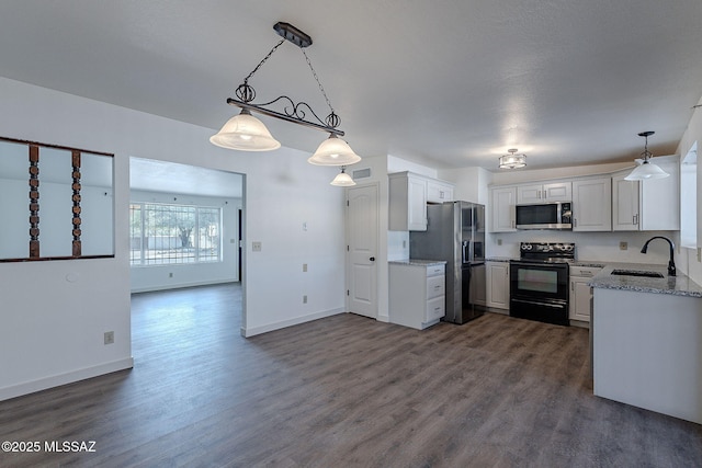 kitchen featuring pendant lighting, white cabinetry, sink, and stainless steel appliances