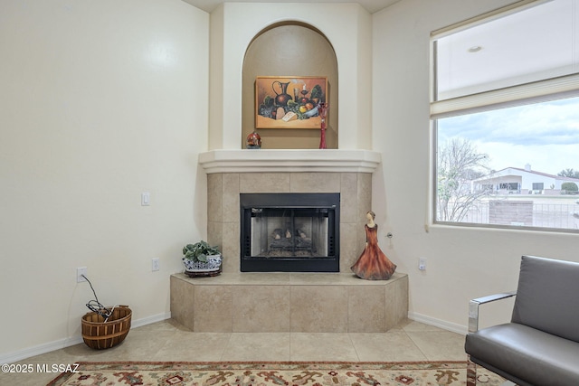 tiled living room featuring a tiled fireplace