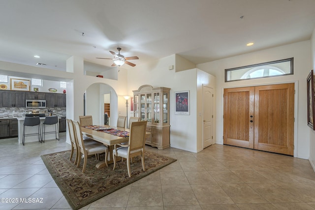 tiled dining room featuring ceiling fan