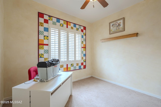 office space featuring ceiling fan and light colored carpet