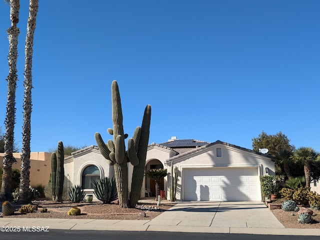 view of front of home with a garage and solar panels