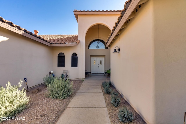 view of exterior entry featuring a patio