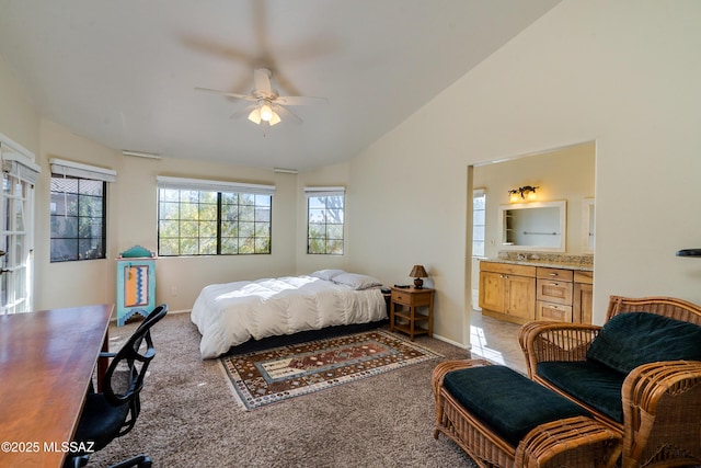 bedroom with connected bathroom, vaulted ceiling, light colored carpet, and ceiling fan