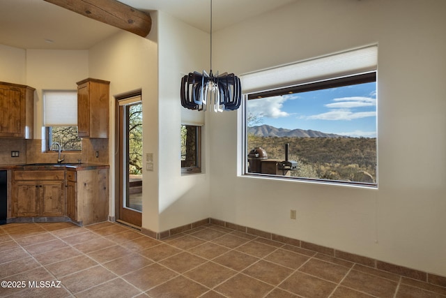 unfurnished dining area with a mountain view and sink