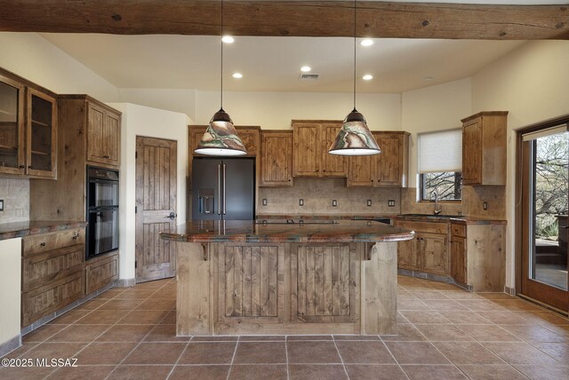 kitchen featuring tasteful backsplash, dark stone counters, black appliances, and vaulted ceiling