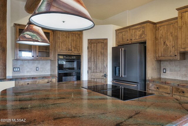 kitchen featuring ceiling fan, black appliances, beam ceiling, a center island, and hanging light fixtures