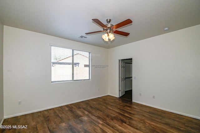 spare room with ceiling fan and dark hardwood / wood-style floors