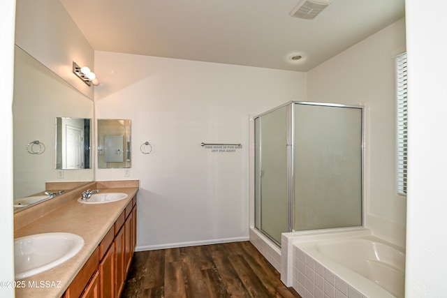 bathroom featuring independent shower and bath, vanity, and hardwood / wood-style flooring