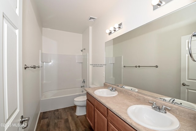 full bathroom with toilet, hardwood / wood-style flooring, shower / bathing tub combination, and vanity