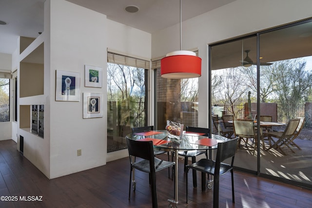 dining space with dark hardwood / wood-style flooring