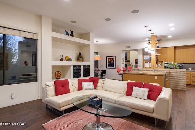 living room featuring wine cooler, built in features, and dark wood-type flooring