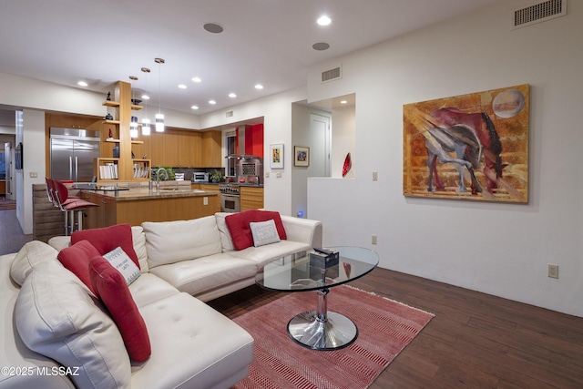 living room featuring sink and dark hardwood / wood-style floors